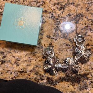 Silver flower necklace.  Close fit.  Beautiful with anything you wear.